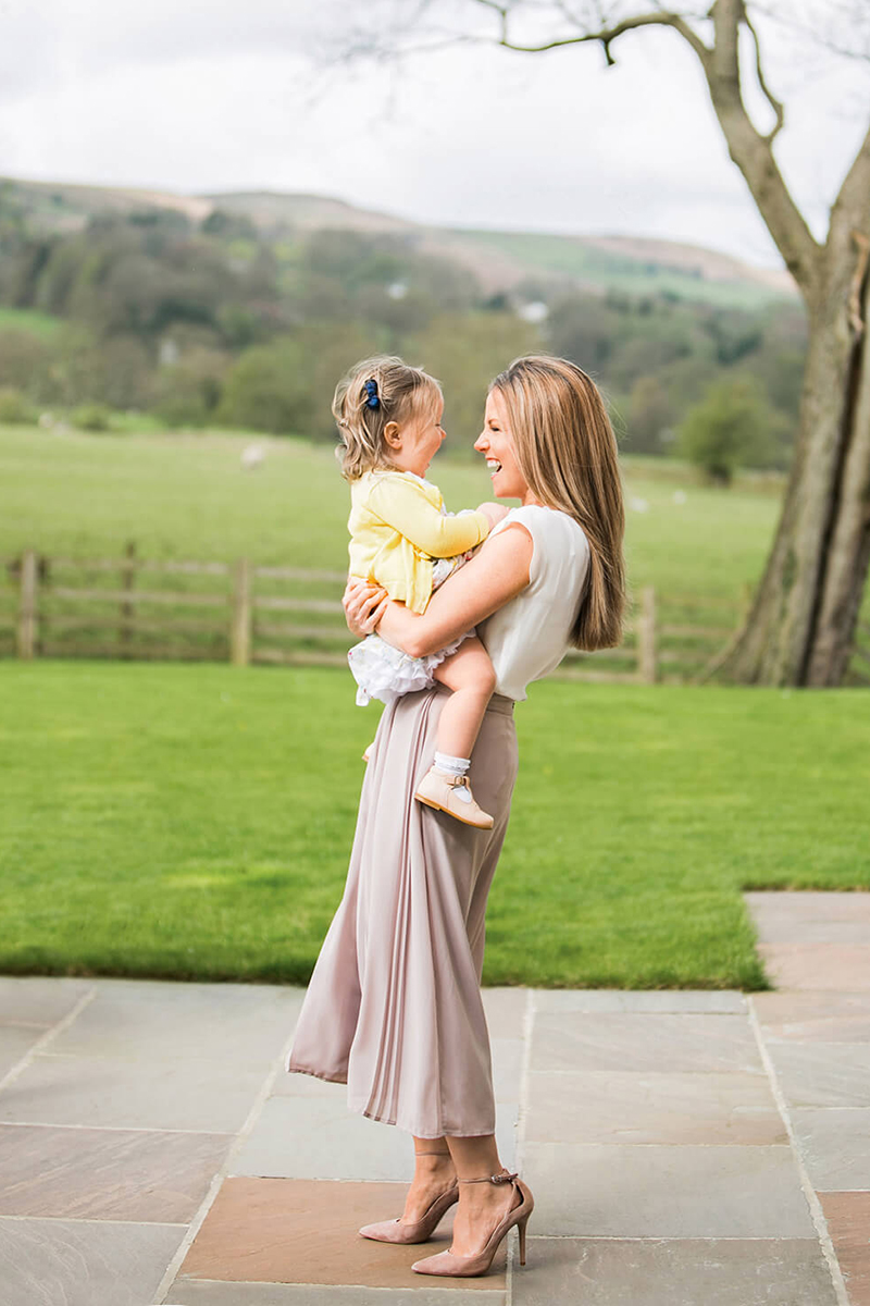 Colour photograph of a beautiful Mum and daughter in the garden in Ilkley