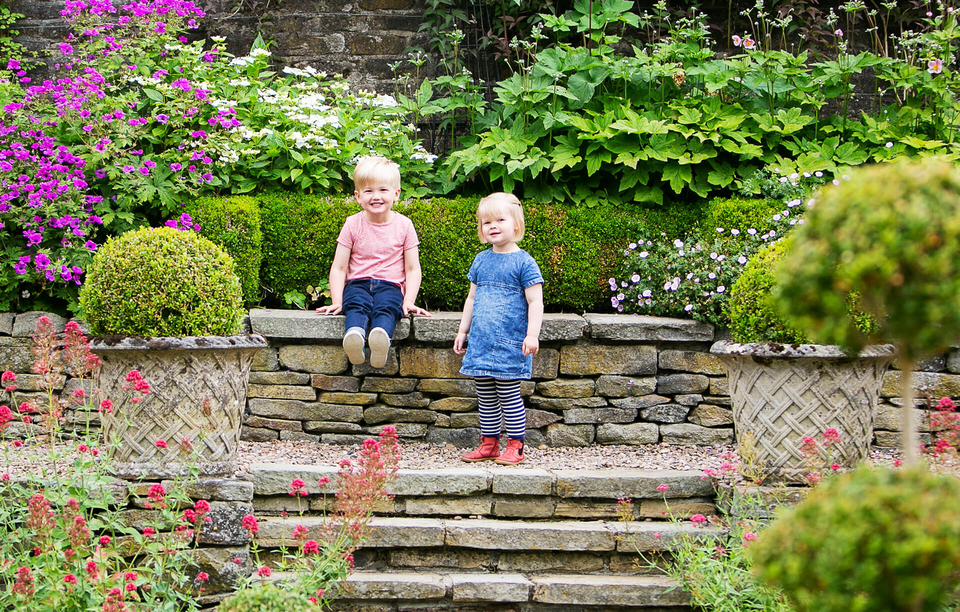Colour photo of young brother and sister on steps at Holdsworth House, Halifax