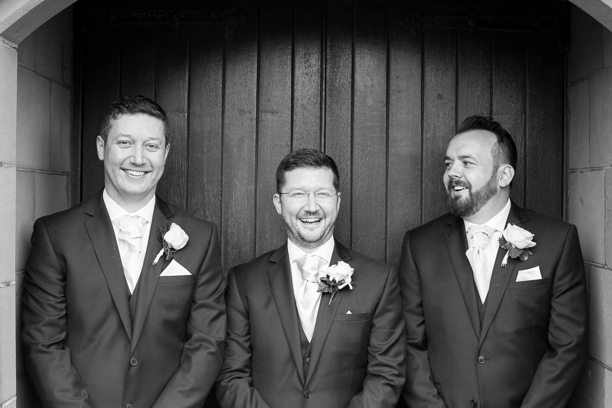 black and white photo of groom and best men