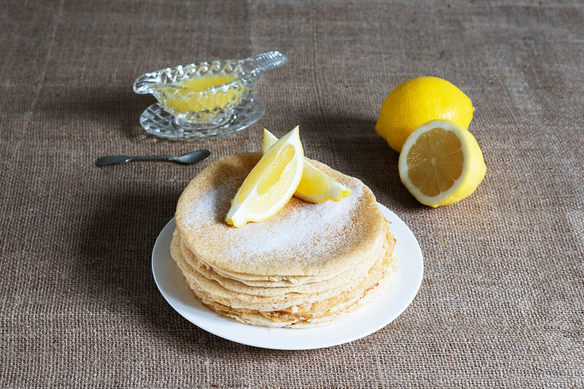 go low pancakes stacked and sprinkled with sugar and lemon