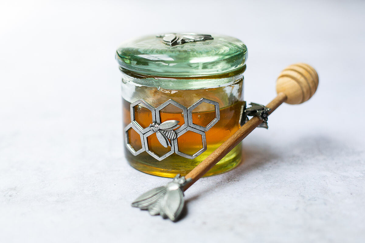 jar of honey with a bee motif
